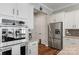 Bright kitchen with stainless steel appliances, white cabinets, and hardwood floors at 2009 Freeport Dr, Indian Trail, NC 28079