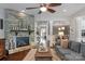 Inviting living room featuring a stone fireplace, hardwood floors, and an open layout to the dining area at 2009 Freeport Dr, Indian Trail, NC 28079