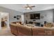 Cozy living room featuring a large-screen TV, comfortable leather seating, and modern entertainment setup at 2009 Freeport Dr, Indian Trail, NC 28079