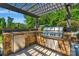 Outdoor kitchen with stone facade, stainless steel grill, fridge, and storage for entertaining at 2009 Freeport Dr, Indian Trail, NC 28079