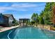 Beautiful pool area featuring a pergola with dining set and a calming rock waterfall feature at 2009 Freeport Dr, Indian Trail, NC 28079
