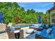 Inviting backyard oasis with a pool, stone waterfall feature, comfortable seating, and lush landscaping at 2009 Freeport Dr, Indian Trail, NC 28079