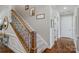 Carpeted staircase with wood and wrought iron railing, next to hardwood floors at 2009 Freeport Dr, Indian Trail, NC 28079