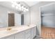 Bright bathroom featuring double vanity sinks, a large mirror, and a bright light fixture at 205 Honey Moss Ln, Salisbury, NC 28146
