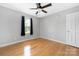 Bedroom features hardwood floors, a ceiling fan, and a window at 205 Honey Moss Ln, Salisbury, NC 28146