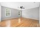 Bright bedroom features hardwood floors, ceiling fan, and two windows at 205 Honey Moss Ln, Salisbury, NC 28146