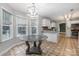 Bright breakfast nook with a glass-top table and large windows at 205 Honey Moss Ln, Salisbury, NC 28146