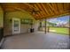 Covered outdoor deck with ceiling fan, gas heater, exterior TV, and wood flooring at 205 Honey Moss Ln, Salisbury, NC 28146