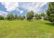 Expansive green lawn with trees and a view of a house in the distance at 205 Honey Moss Ln, Salisbury, NC 28146