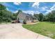 Spacious home featuring a side-entry garage, a fenced-in yard, and lush landscaping at 205 Honey Moss Ln, Salisbury, NC 28146