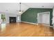 Bright living room showcasing a fireplace, vaulted ceilings, and hardwood floors at 205 Honey Moss Ln, Salisbury, NC 28146
