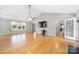 Spacious living room with hardwood floors, a ceiling fan, and large windows for natural light at 205 Honey Moss Ln, Salisbury, NC 28146