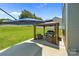 Inviting back patio with a gazebo, comfortable seating, and an umbrella in a lush backyard at 2301 Amesbury Ct, Albemarle, NC 28001