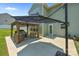 Inviting back patio with a gazebo, comfortable seating, and a large backyard at 2301 Amesbury Ct, Albemarle, NC 28001