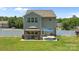 Spacious backyard features a gazebo with seating, an umbrella, and a white fence, perfect for outdoor enjoyment at 2301 Amesbury Ct, Albemarle, NC 28001