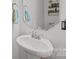 A bathroom with a white pedestal sink, a mirror, and decor at 2301 Amesbury Ct, Albemarle, NC 28001