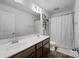 Bright bathroom features a double sink vanity with dark wood cabinets, a large mirror, and shower and tub combo at 2301 Amesbury Ct, Albemarle, NC 28001