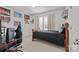 Cozy bedroom featuring neutral carpeting, decor, and a black desk chair perfect for studying and relaxing at 2301 Amesbury Ct, Albemarle, NC 28001