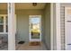 Inviting entryway with a glass-paneled front door, welcome mat, and house number clearly displayed at 2301 Amesbury Ct, Albemarle, NC 28001