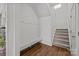 An entryway with a bench, coat hooks, a staircase, and wood floors at 2301 Amesbury Ct, Albemarle, NC 28001