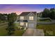 Charming two-story home with gray siding, attached garage, and a cozy front porch with lush landscaping at 2301 Amesbury Ct, Albemarle, NC 28001