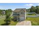 Charming two-story home with gray siding, attached garage, and a cozy front porch with lush landscaping at 2301 Amesbury Ct, Albemarle, NC 28001