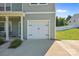 Close-up of the home's garage, showing the clean white door, and adjacent walkway at 2301 Amesbury Ct, Albemarle, NC 28001