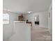 Bright hallway showcasing neutral walls, with view into bedroom space at 2301 Amesbury Ct, Albemarle, NC 28001