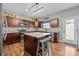 Well-lit kitchen showcasing wood cabinets, stainless steel appliances, and a center island with barstool seating at 2301 Amesbury Ct, Albemarle, NC 28001