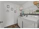 Well-organized laundry room featuring modern washer and dryer, with decorative shelving and signage at 2301 Amesbury Ct, Albemarle, NC 28001