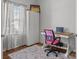 A bright office with wood floors, a desk, a chair, a window, and a large closet at 2301 Amesbury Ct, Albemarle, NC 28001