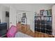 A home office area with a bookcase, a display case, and wood floors throughout at 2301 Amesbury Ct, Albemarle, NC 28001