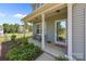 Inviting front porch with seating, decorative plants, and a clear view through the glass front door at 2301 Amesbury Ct, Albemarle, NC 28001