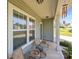 Cozy front porch with seating area, featuring comfortable chairs and a small table with decorative plants at 2301 Amesbury Ct, Albemarle, NC 28001