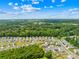 An aerial view showing a meticulously planned community enveloped in mature trees and greenery at 2512 Andes Dr, Statesville, NC 28625