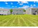Large backyard with green grass, showing the backs of several well-maintained homes at 2512 Andes Dr, Statesville, NC 28625