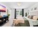 Comfortable bedroom features large windows, a lounge sofa, and neutral color palette at 2512 Andes Dr, Statesville, NC 28625