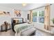 Cozy bedroom with soft grey headboard, bench, layered pillows, soft rug and ample natural light at 2512 Andes Dr, Statesville, NC 28625