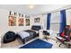 Comfortable bedroom with a gaming chair, posters, desk, blue rug, and plenty of space at 2512 Andes Dr, Statesville, NC 28625