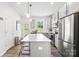 Modern kitchen features stainless steel appliances, pendant lighting, an island, and backyard views at 2512 Andes Dr, Statesville, NC 28625