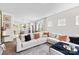 Bright living room features a large sectional sofa, an open layout, and hardwood floors at 2512 Andes Dr, Statesville, NC 28625