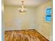 Dining room with chandelier, wainscoting and window offering natural light at 2660 Tiffany St, Conover, NC 28613