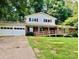 Traditional two-story home featuring a ramp entrance, attached garage, and lush, green landscaping at 2660 Tiffany St, Conover, NC 28613