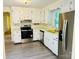 White kitchen with stainless steel appliances and laminate flooring at 2660 Tiffany St, Conover, NC 28613