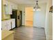 Kitchen with white cabinets, stainless steel refrigerator, and laminate flooring at 2660 Tiffany St, Conover, NC 28613