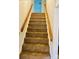 Carpeted stairs with wooden railing at 2660 Tiffany St, Conover, NC 28613