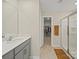 Bright bathroom featuring a single sink vanity, walk-in closet, and a glass-enclosed shower at 404 Saddlebred Ln, Locust, NC 28097