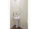 Neat half bathroom features a pedestal sink and modern mirror at 404 Saddlebred Ln, Locust, NC 28097
