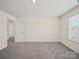 Spacious bedroom with neutral walls, neutral carpet and a light-filled atmosphere at 404 Saddlebred Ln, Locust, NC 28097