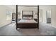 Spacious bedroom featuring a large bed, mirrored closet, and plenty of natural light from the windows at 404 Saddlebred Ln, Locust, NC 28097